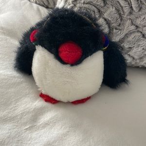 Gund penguin toy wearing earmuffs. Has a squeaker in its left flipper. rare